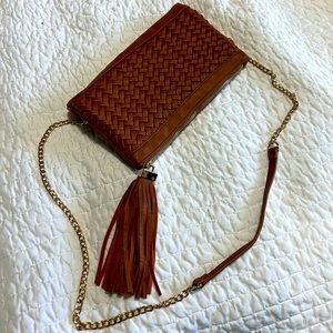 Clutch with chain strap for shoulder or cross body wear.